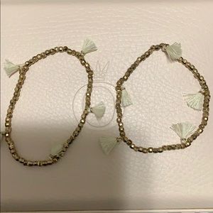 Gold bracelet with white tassels